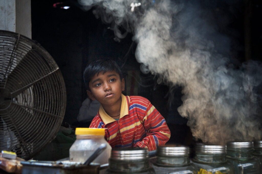 Photo of young street vendor with smoke.