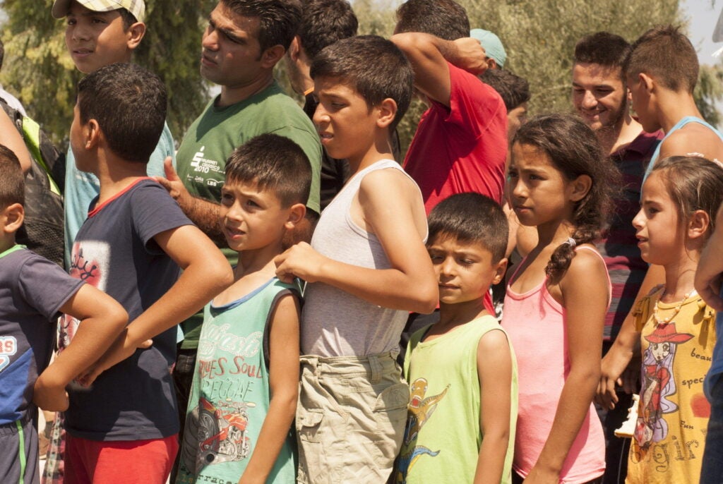 Photo of children waiting in line for food.
