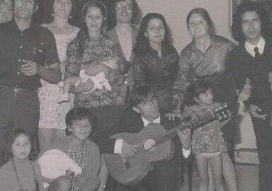 Family gathered around guitarist