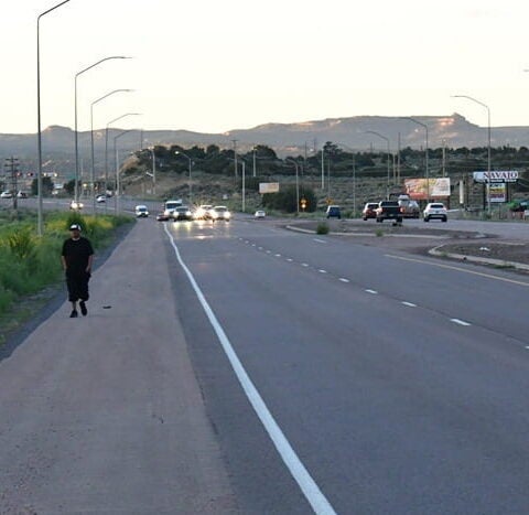 Calvin Gorman, 50, left, walks last year near Gallup, N.M., on the way from his job in Gallup to his home in Fort Defiance, Ariz., part of the Navajo Nation. American Indians in Western and Midwestern states had the lowest life expectancy of any group in the country in 2021. (Tim Henderson/Stateline)