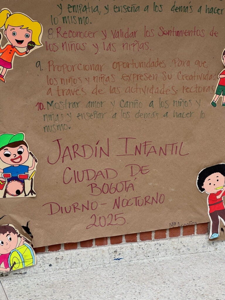 Colombia 2025, paper sign on brick wall about children's play garden in the city of Bogota. Photo courtesy of Jacqueline Bhabha.