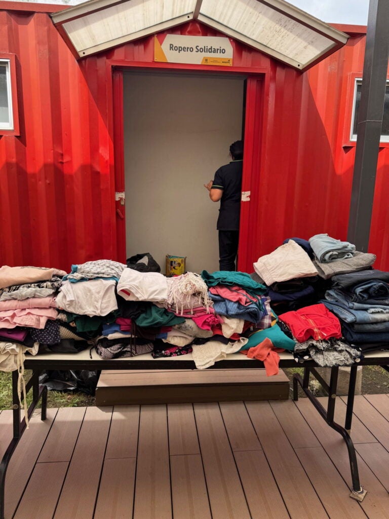 Colombia 2025, donated clothes for migrants folded on table. Photo courtesy of Jacqueline Bhabha.