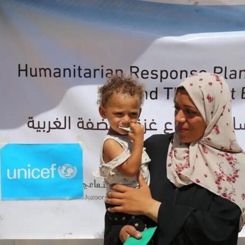 A mother holds her 1-year-old daughter, Asmaa, outside a UNICEF malnutrition screening and treatment point in Khan Younis, southern Gaza Strip on May 25, 2025. “Asmaa started losing weight a few months ago because it was really difficult to find anything to eat. Nothing is available, and I can hardly provide any food for my baby. She started to improve slightly when she began eating the nutrition supplements provided here. She now weighs nine kilos — before, she only weighed five.” © UNICEF/UNI804944/El Baba