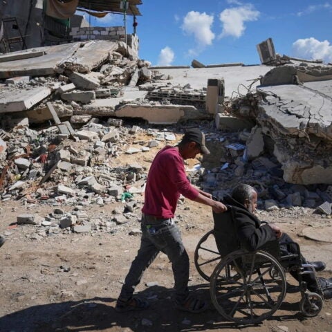 A man escorting his father to Al-Shifa Hospital for a dialysis session, Gaza City, April 14, 2025. Jehad Alshrafi/AP.