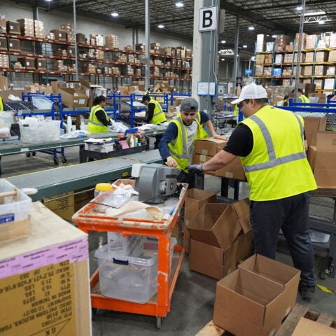 Image of workers in website with boxes