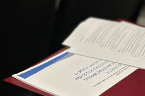 Photo of red folder with worksheets for G. Barrie Landry Child Protection Professional Training program