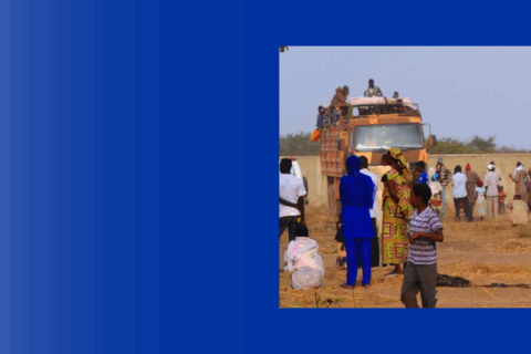 Photo of people in transit across open plain.