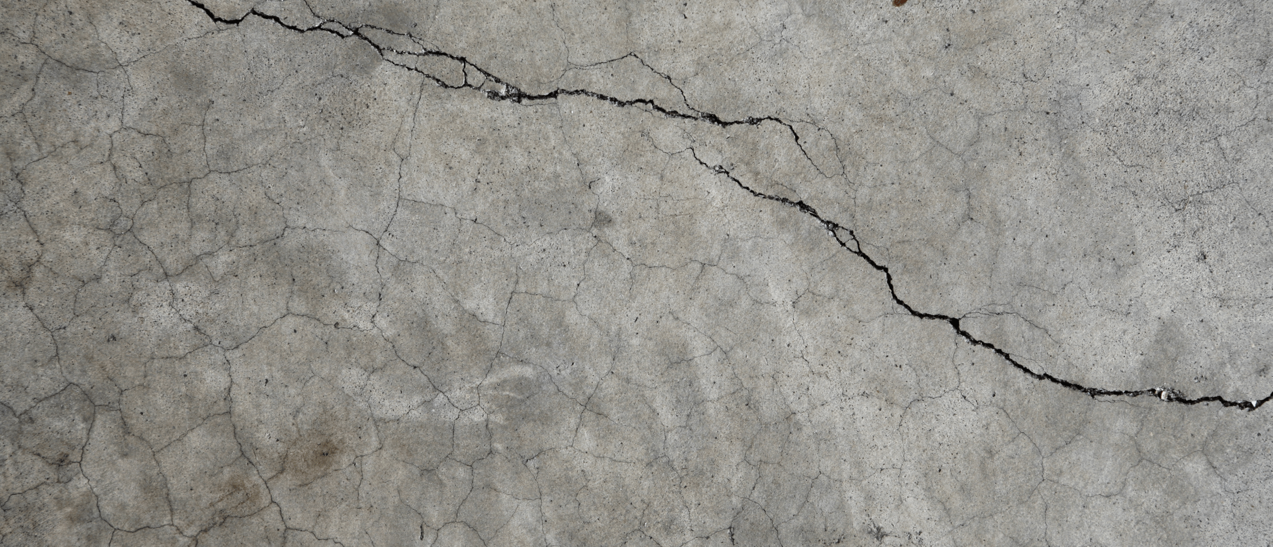Image of crack going across grey concrete