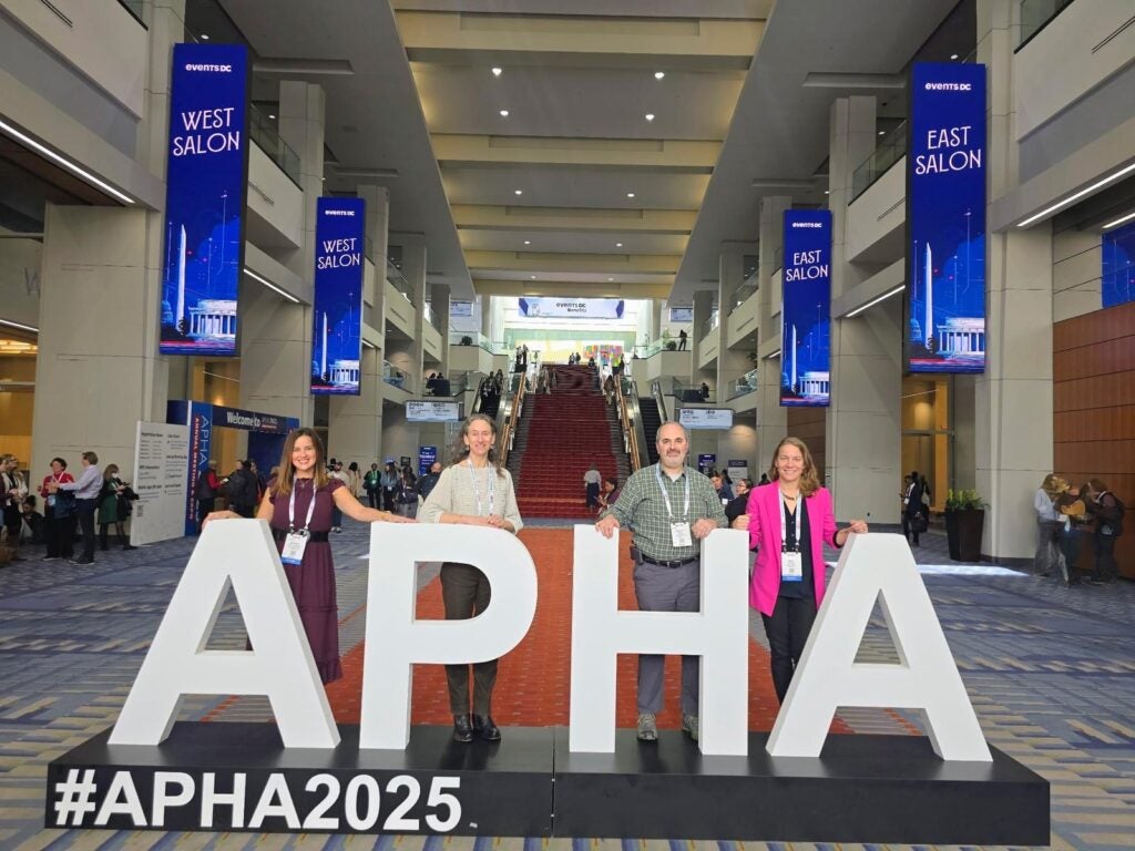 Dr. Margaret Sullivan and colleagues posing with the APHA 2025 sign during the 2025 APHA Annual Meeting in Washington, D.C.