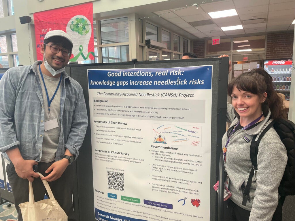 Soroush Moallef and Michelle Whittaker in front of a poster they presented on at the Boston Health Care for the Homeless Program Research Day.