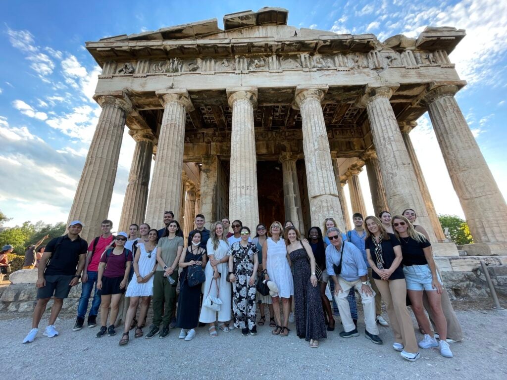 Summer course on migration and refugee studies 2022 cohort in front of Temple of Hephaestus in Athens, Greece.