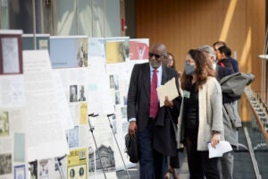 David Williams and Natalia Linos viewing the Legacies of Eugenics exhibition posters at the Martin Center on April 6, 2023.
