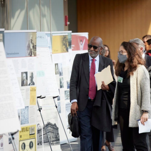 David Williams and Natalia Linos viewing the Legacies of Eugenics exhibition posters at the Martin Center on April 6, 2023.