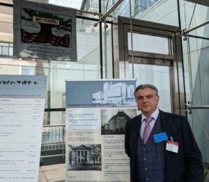 The curator of the "We Are Not Alone": Legacies of Eugenics exhibition, Professor Marius Turda, next to exhibition posters at the Martin Center on April 6, 2023.