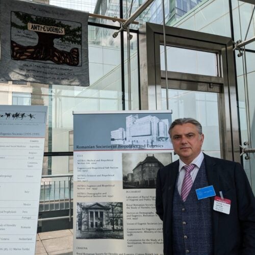 The curator of the "We Are Not Alone": Legacies of Eugenics exhibition, Professor Marius Turda, next to exhibition posters at the Martin Center on April 6, 2023.