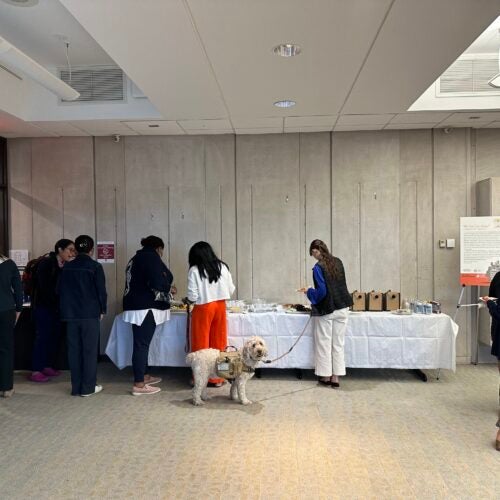 Attendees arriving and getting refreshments at he opening of the Exhibition “We Are Not Alone”: Legacies of Eugenics at Harvard's Countway Library