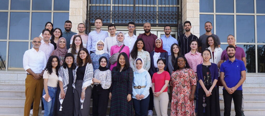 2023 cohort of Palestine Program's social medicine course. Group of students standing on marble steps.