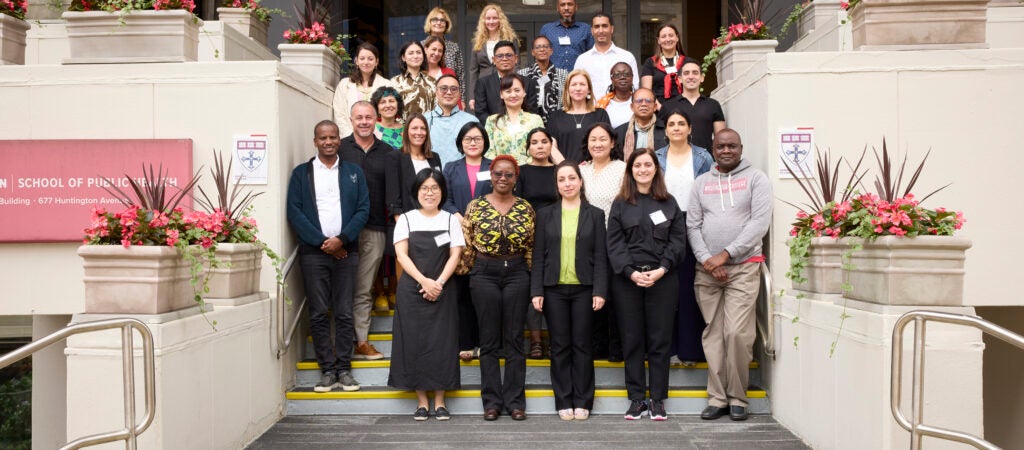 Group photo of 2024 FXB Landry Program participants standing at the steps in front of the Harvard School of Public Health.